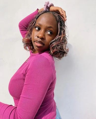 Worthy in a pink top, the writer behind the notepad